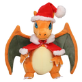 Plush toy of a dragon-like creature wearing a Santa hat and scarf on a white background